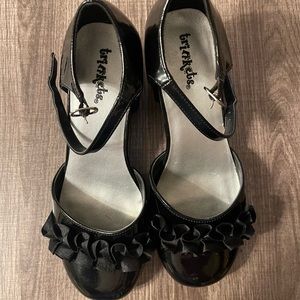 Gently Used Trinkets patent leather like black buckle up shoes. Size 4M